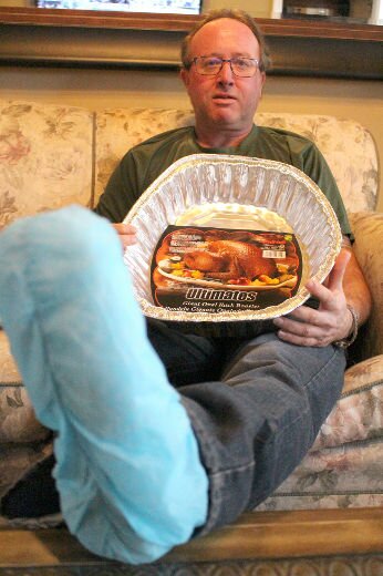 Harding holds crap pan he bought at a dollar store and shows his bandaged foot with second degree burns! Shakedown lawsuit?